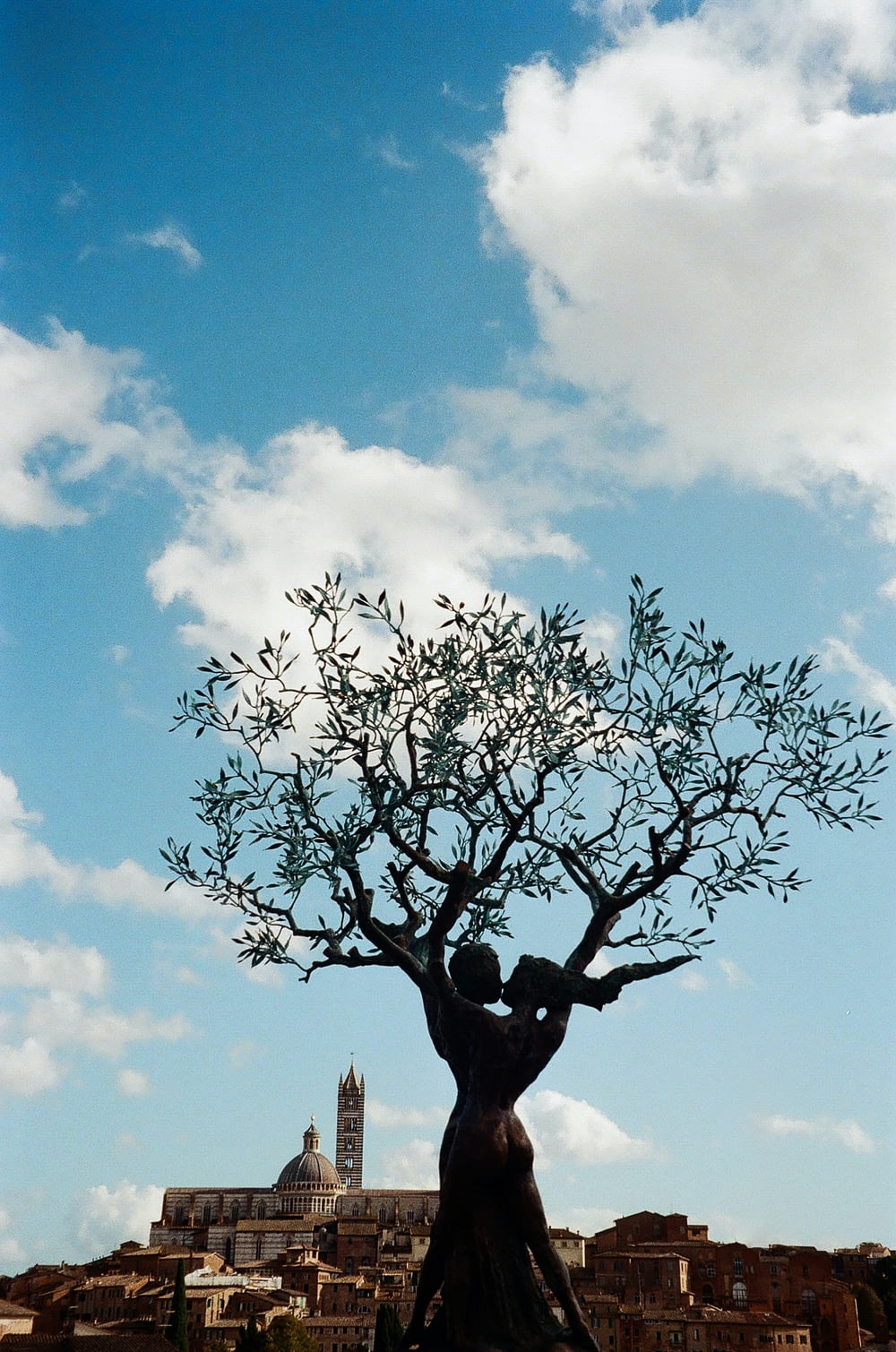 a statue of a tree with a sky background