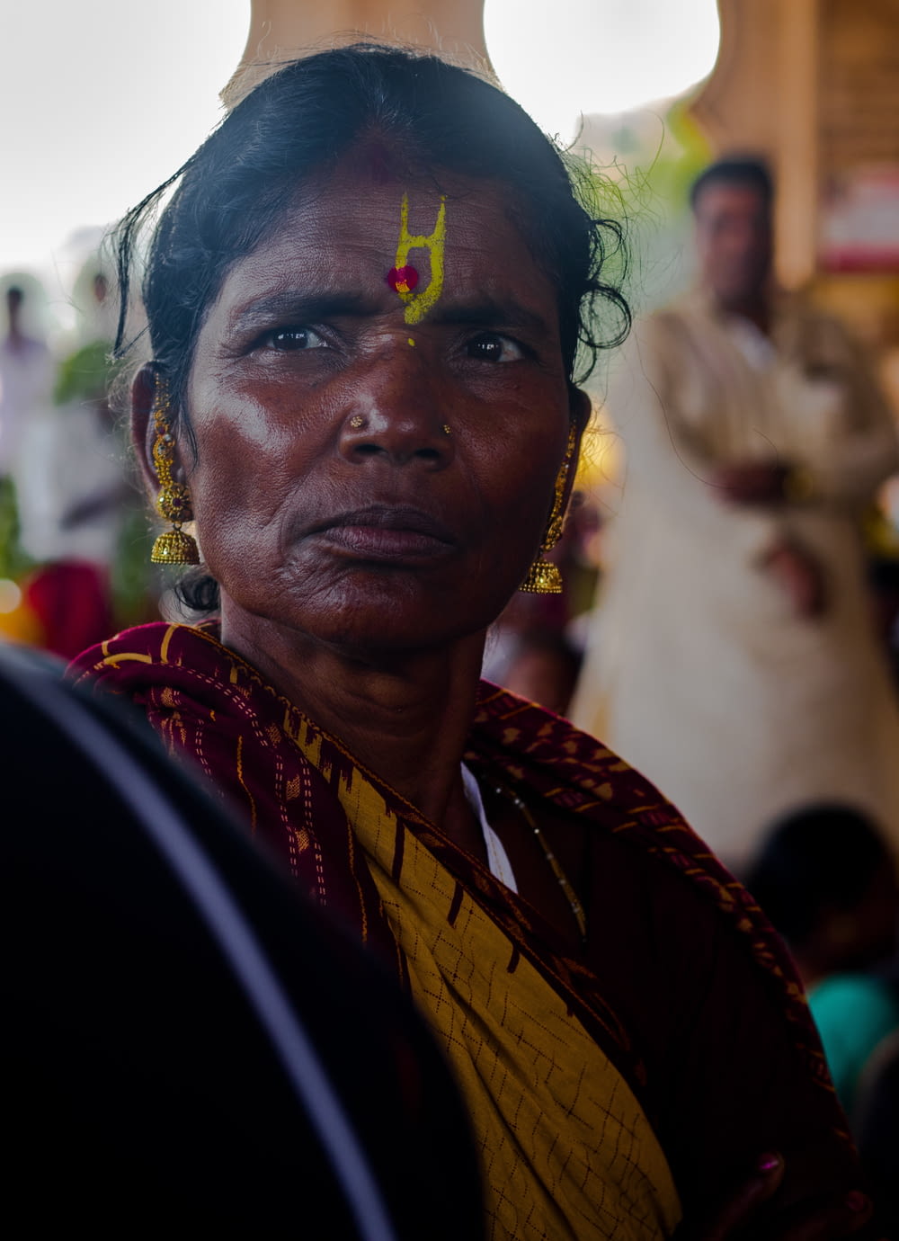 a woman with a yellow cross on her forehead