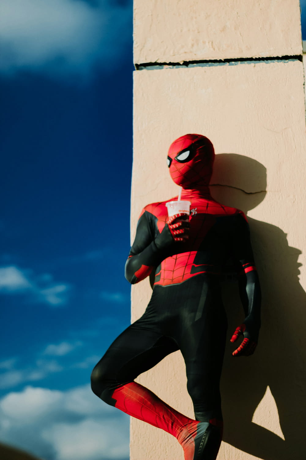 Un homme-araignée debout à côté d’un bâtiment