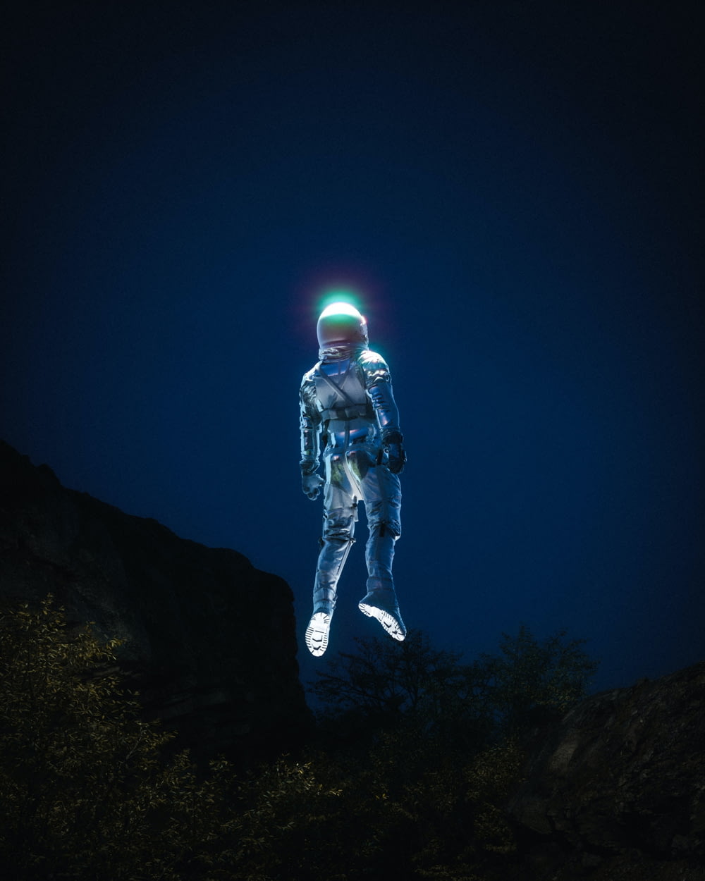 un uomo in tuta spaziale in piedi in cima a una collina