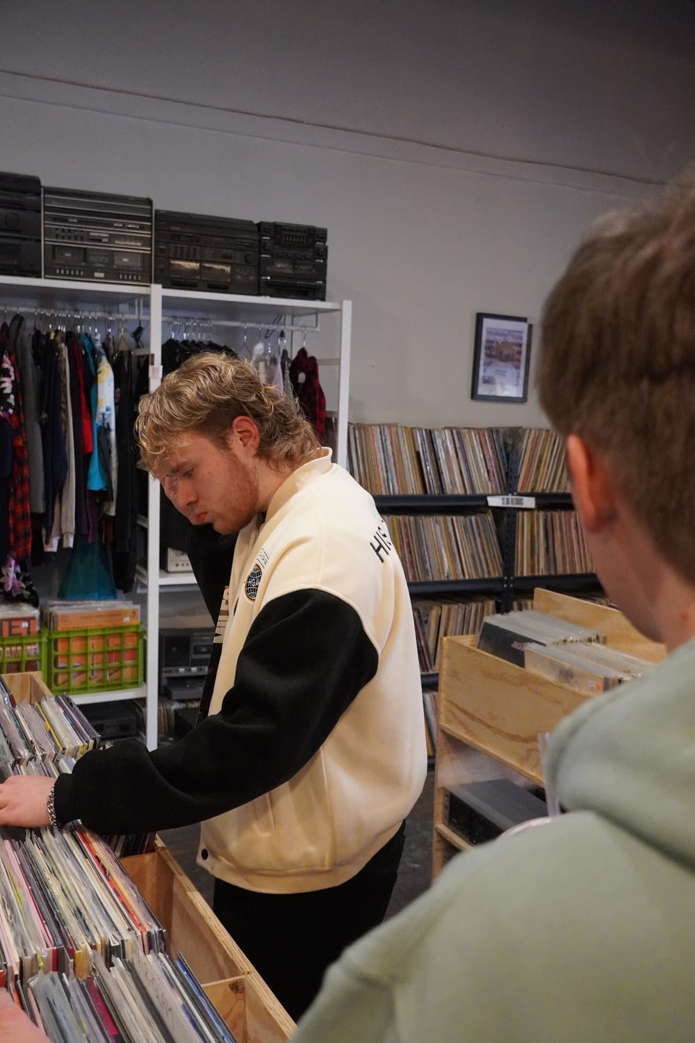 a man looking at records in a record store
