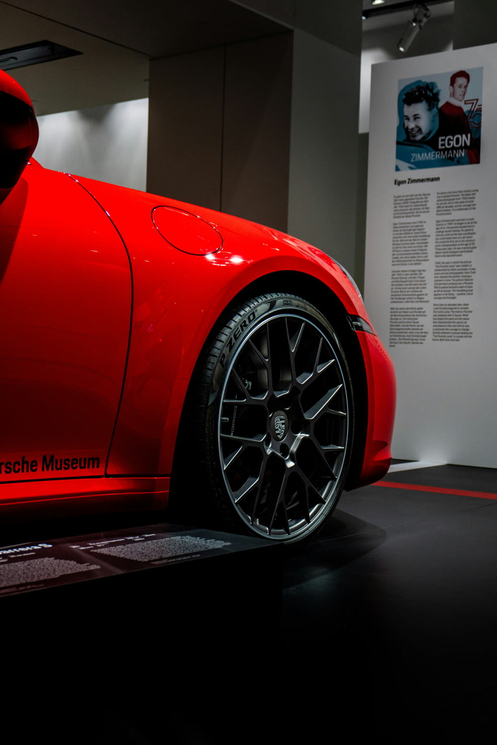 a red sports car on display in a museum