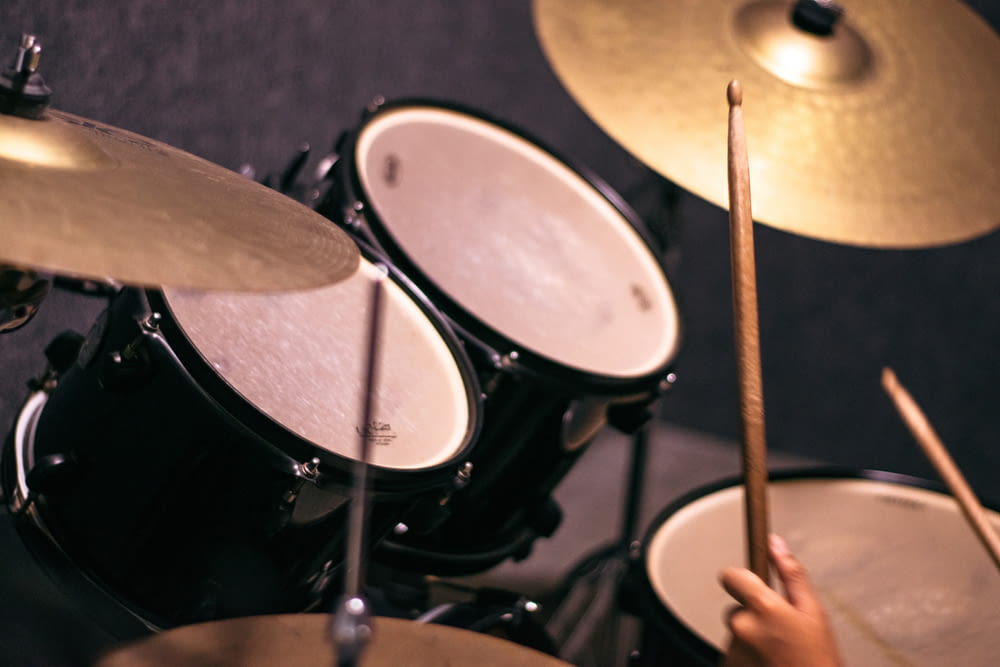 a person is playing drums in a recording studio