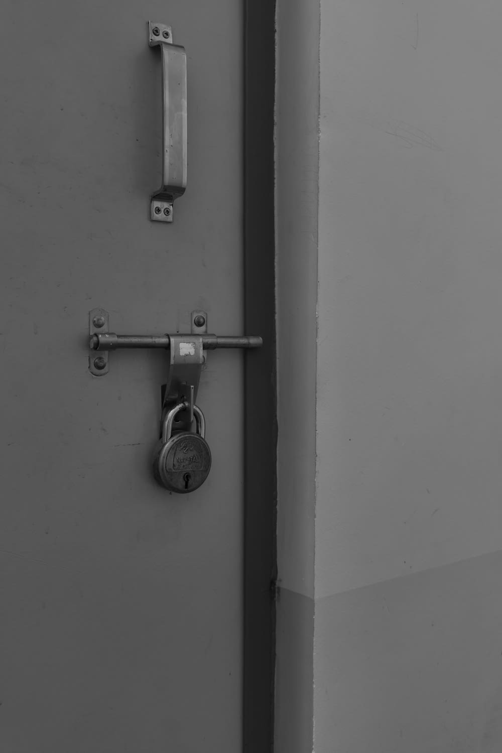 a black and white photo of a lock on a door