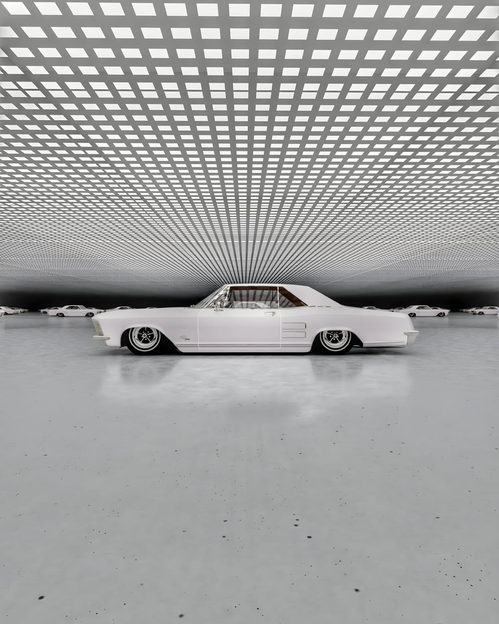 a white car is parked in a large room