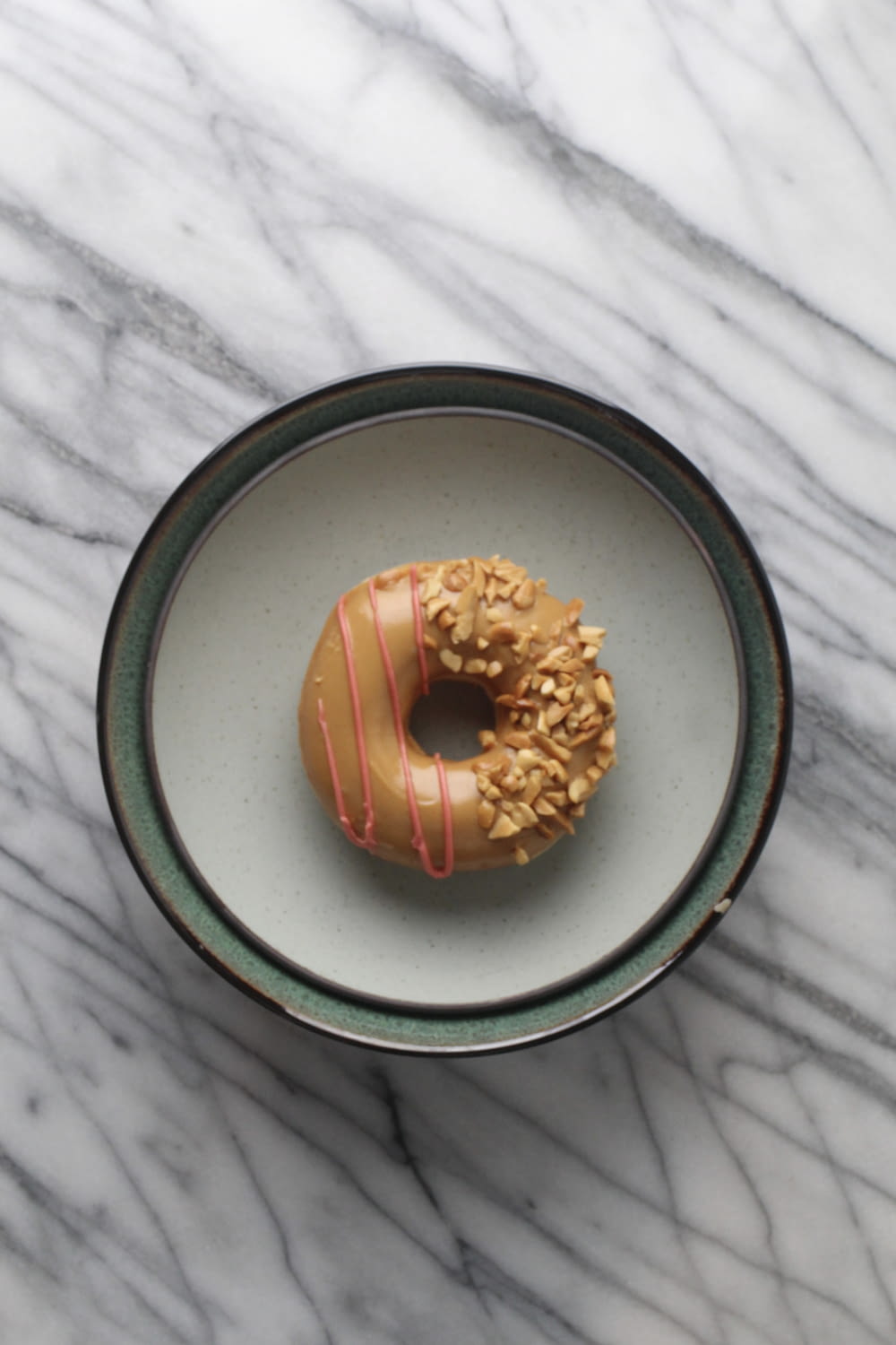 a glazed donut with sprinkles on a plate