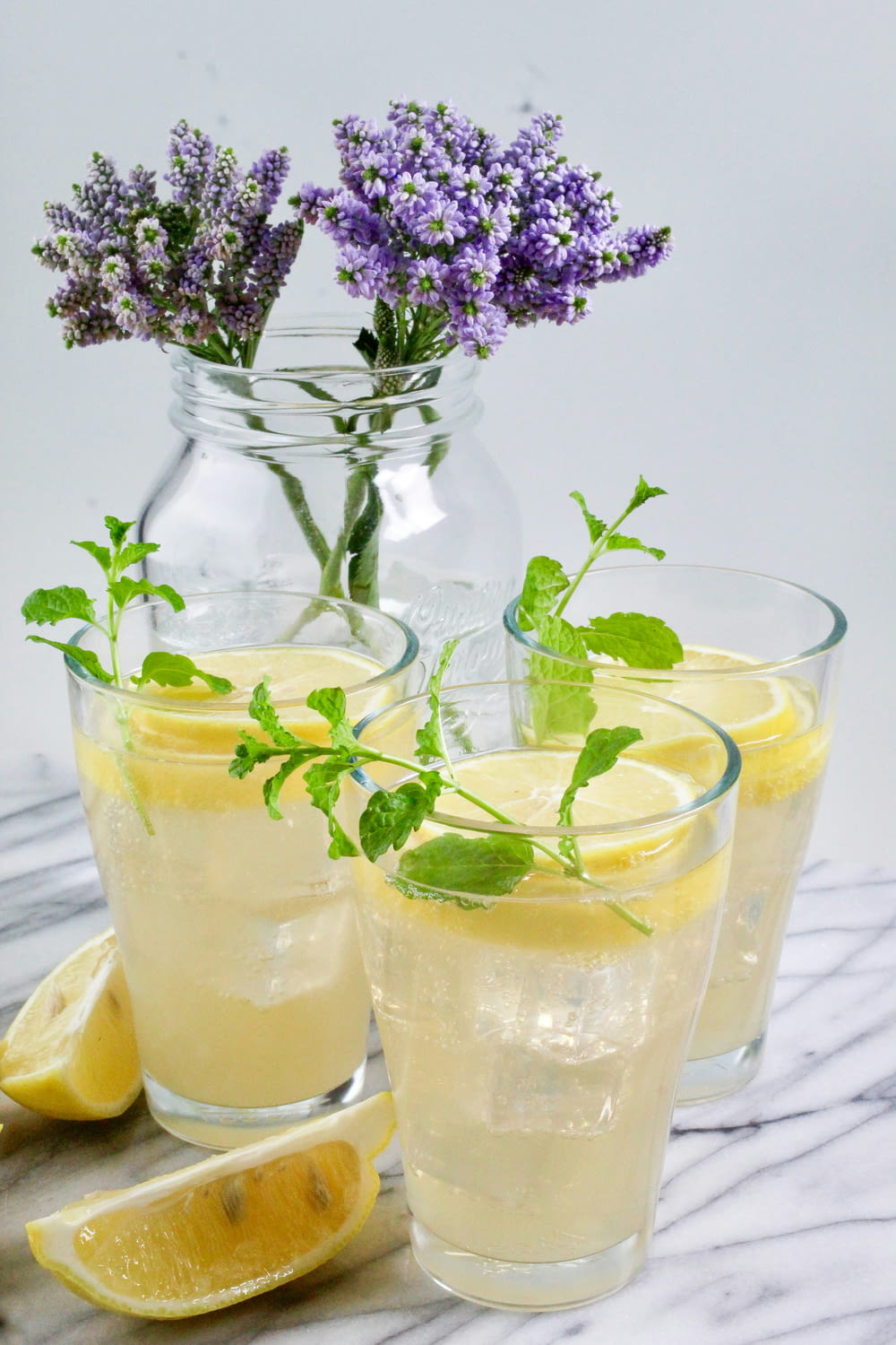 a pitcher of lemonade and two glasses of lemonade