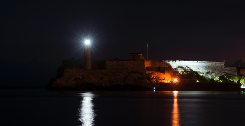 a large castle lit up at night with lights on
