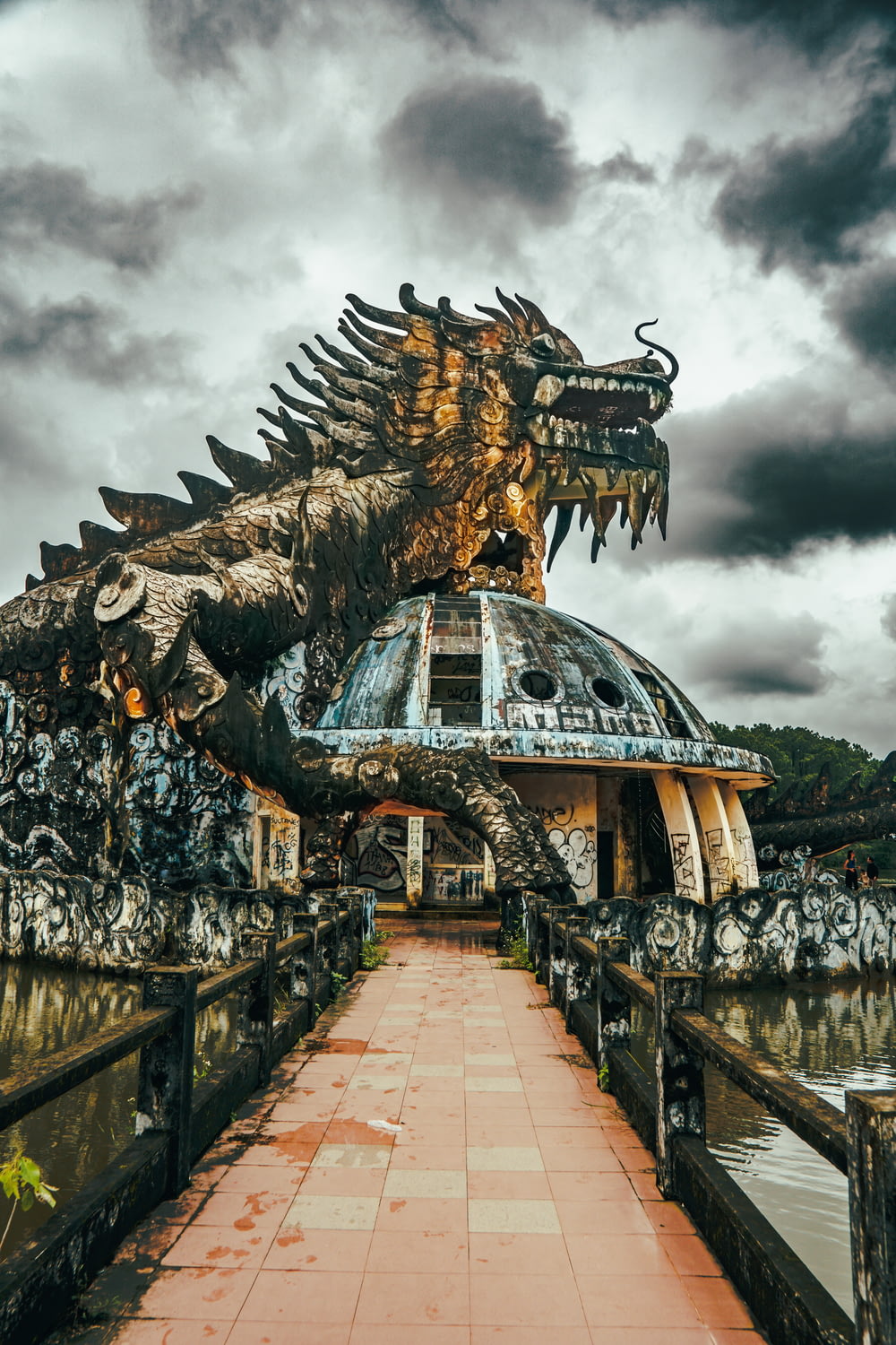 a large dragon statue sitting on top of a bridge