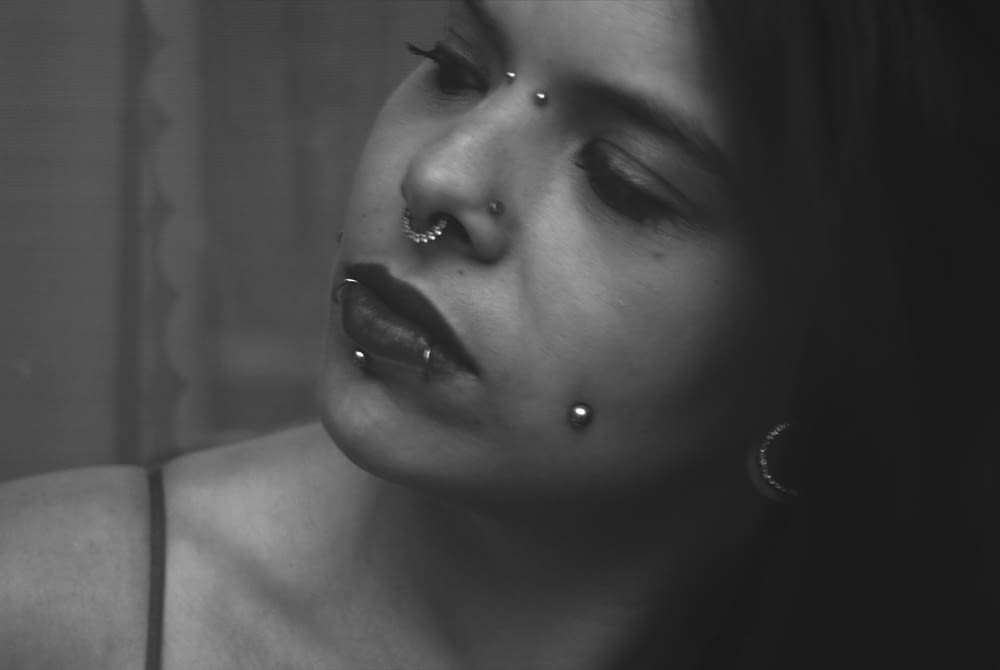 a woman with piercings on her nose and nose ring