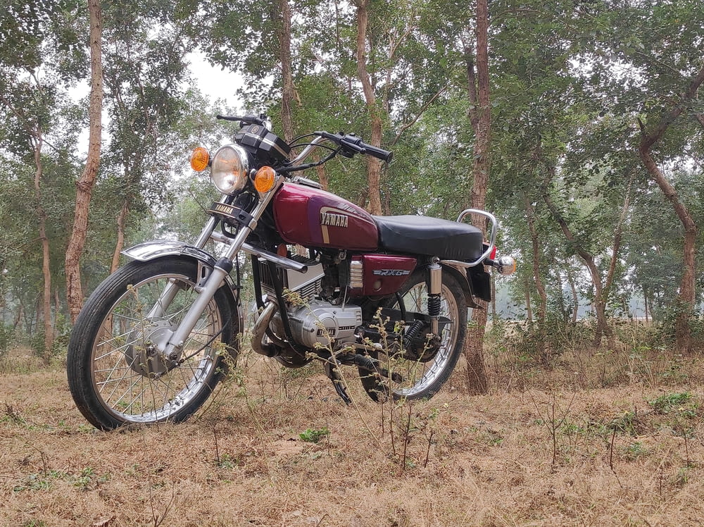 a motorcycle parked in the middle of a forest