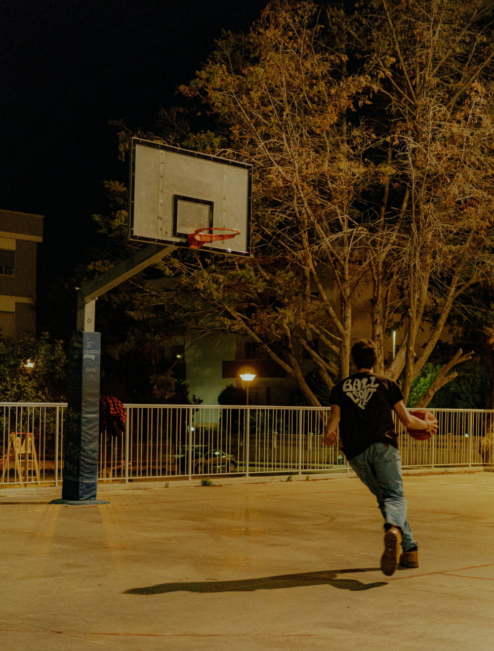 a young man is playing basketball on a court
