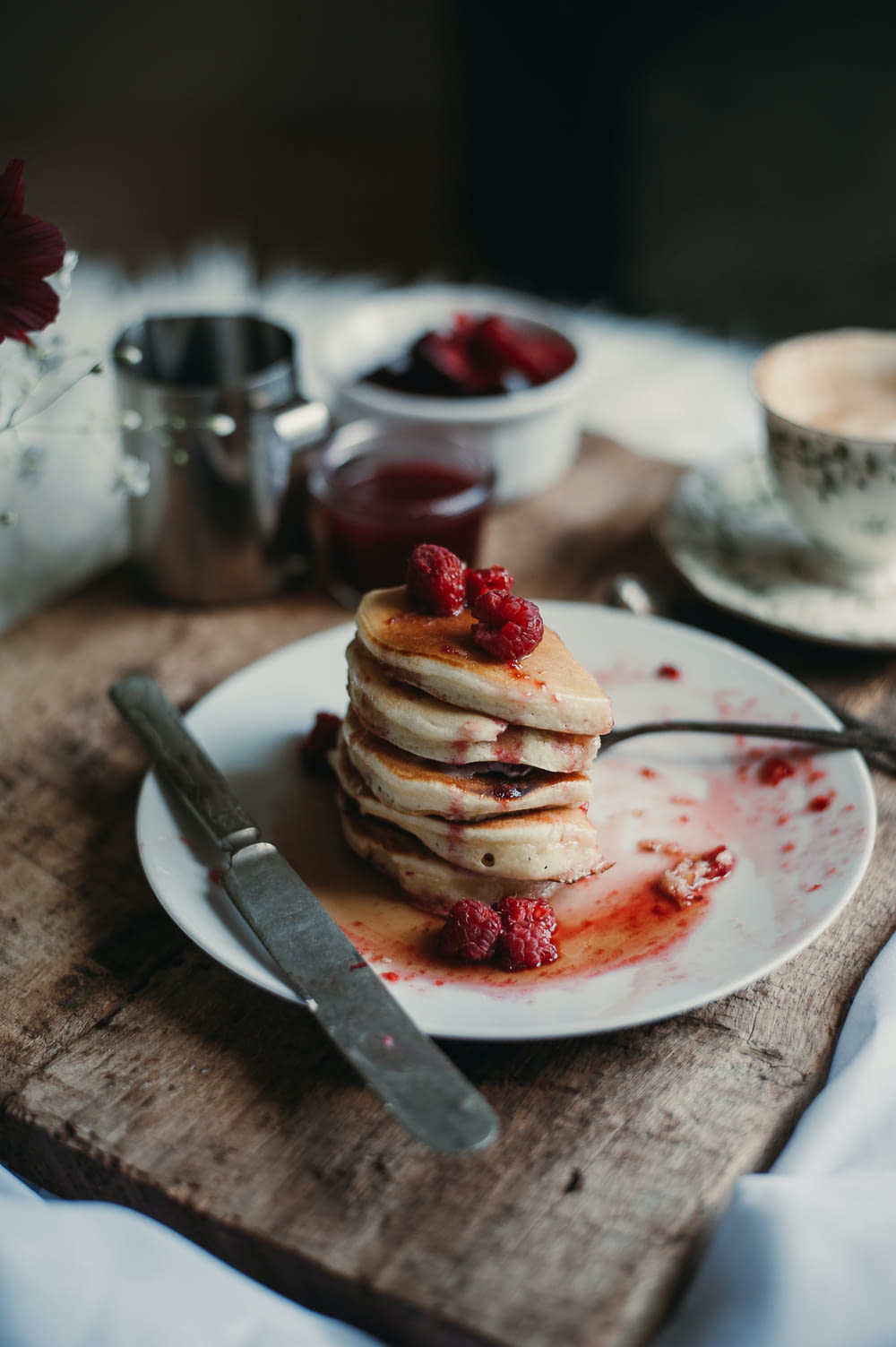 a stack of pancakes with strawberries on a plate