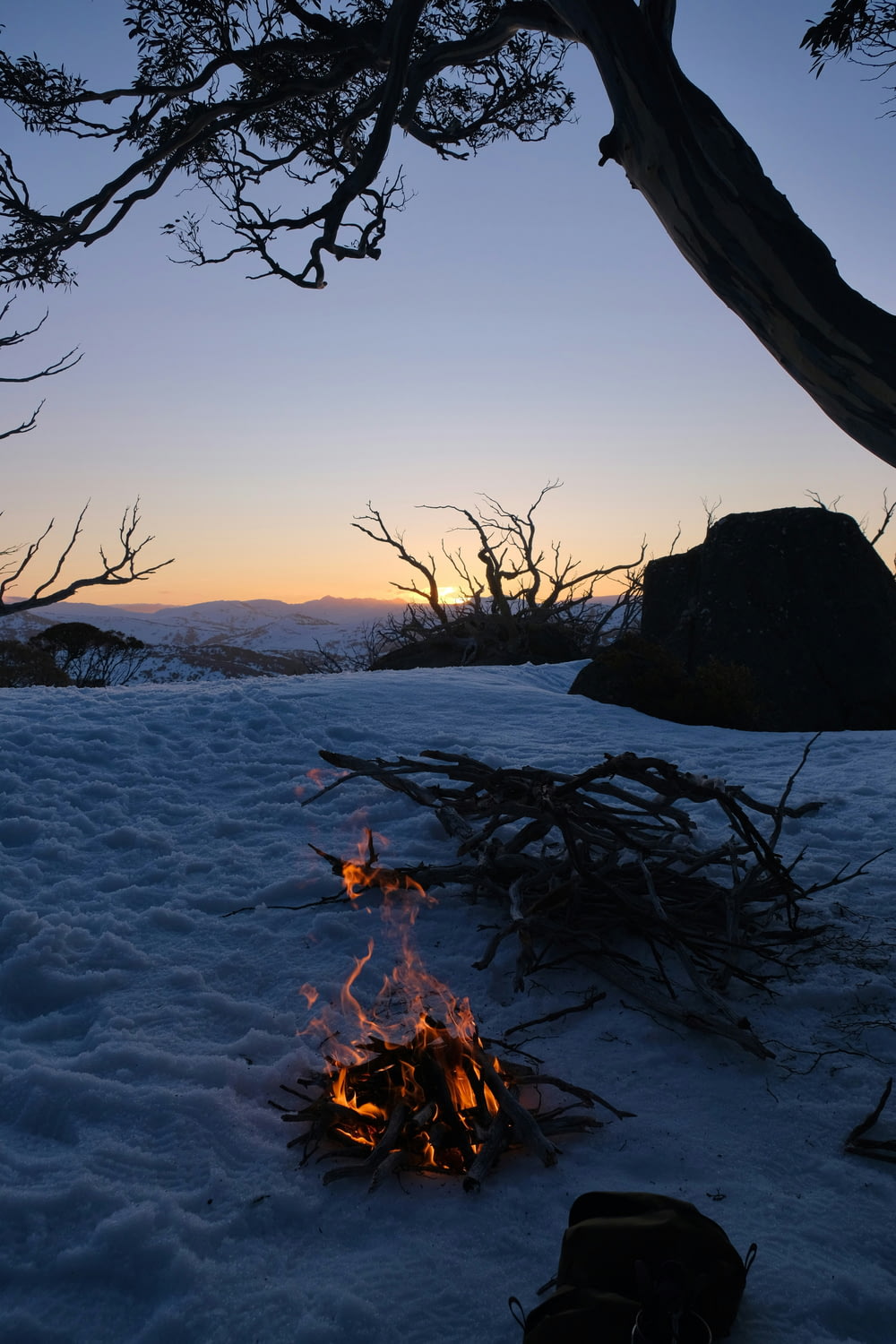 a campfire in the middle of a snowy field