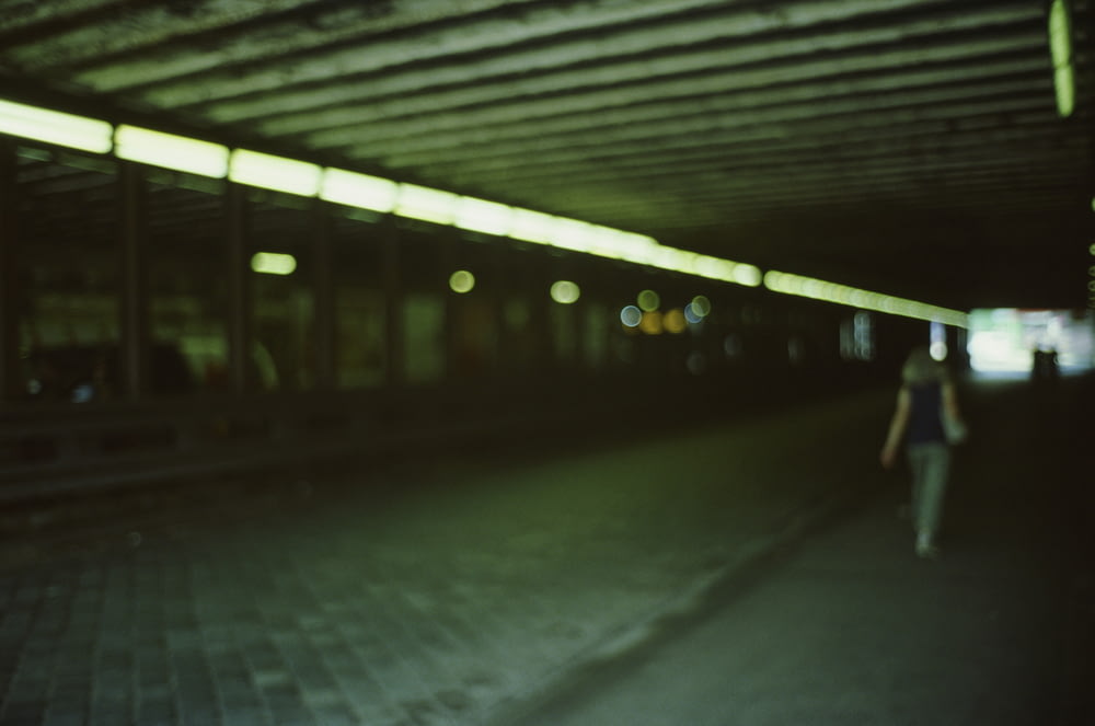 a blurry photo of a person walking down a sidewalk