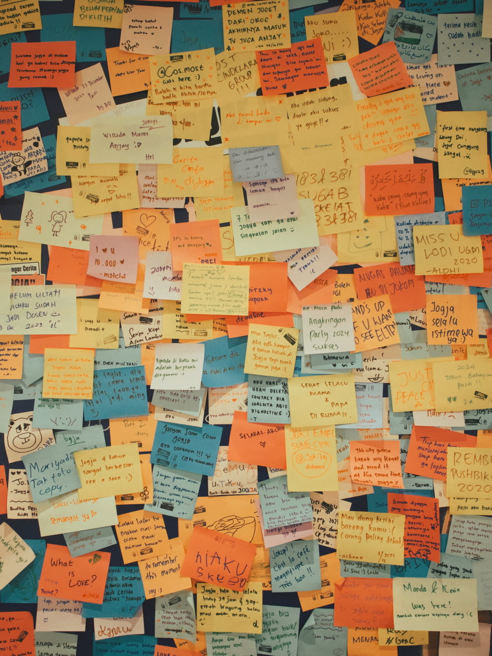 a bulletin board covered in lots of post it notes