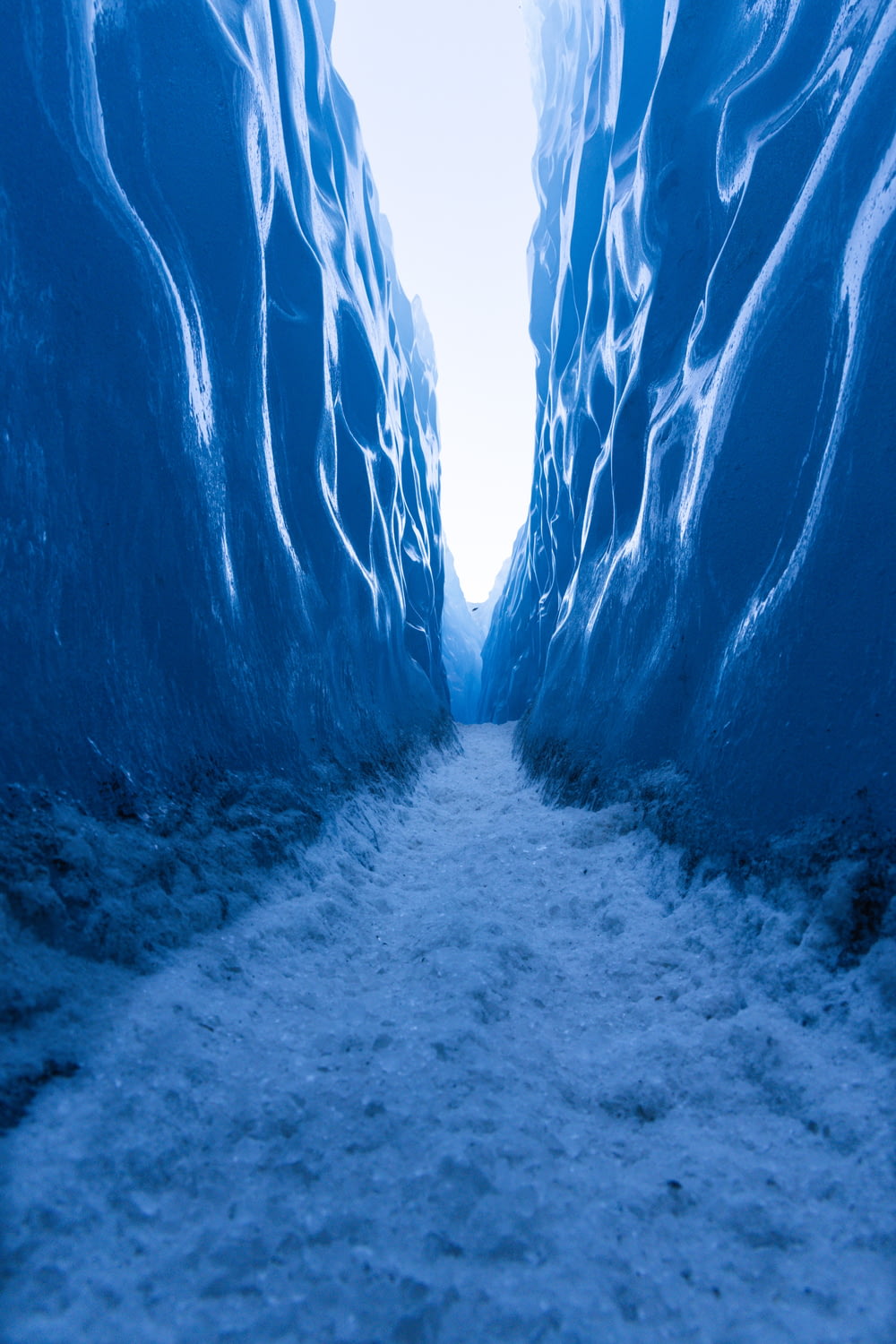 a narrow narrow road with ice on the sides
