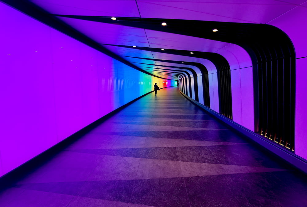 a person is walking down a long tunnel
