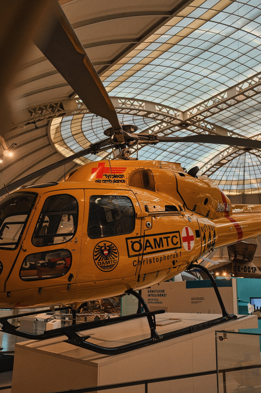 a yellow helicopter is on display in a museum