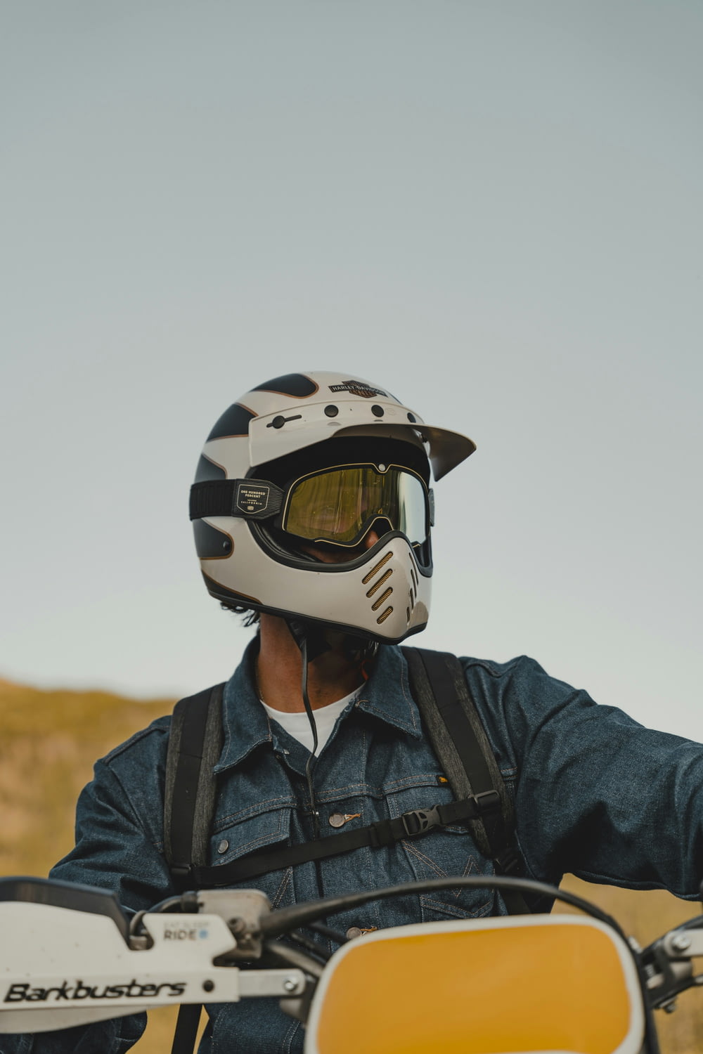 a man wearing a helmet sitting on a motorcycle