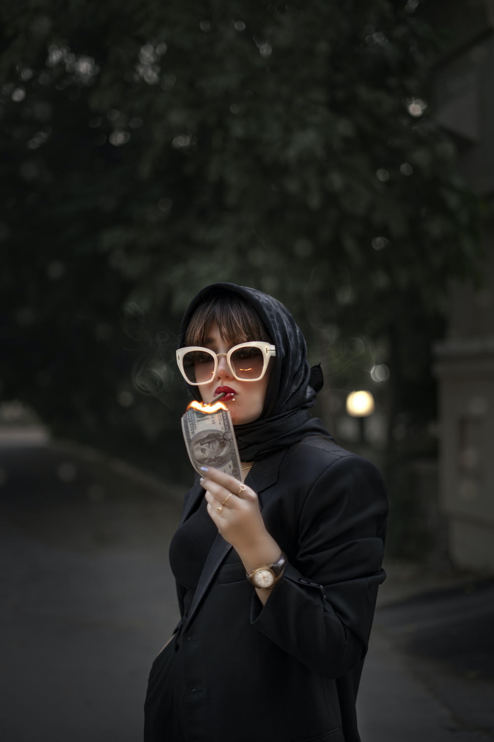 a woman wearing sunglasses holding a cell phone