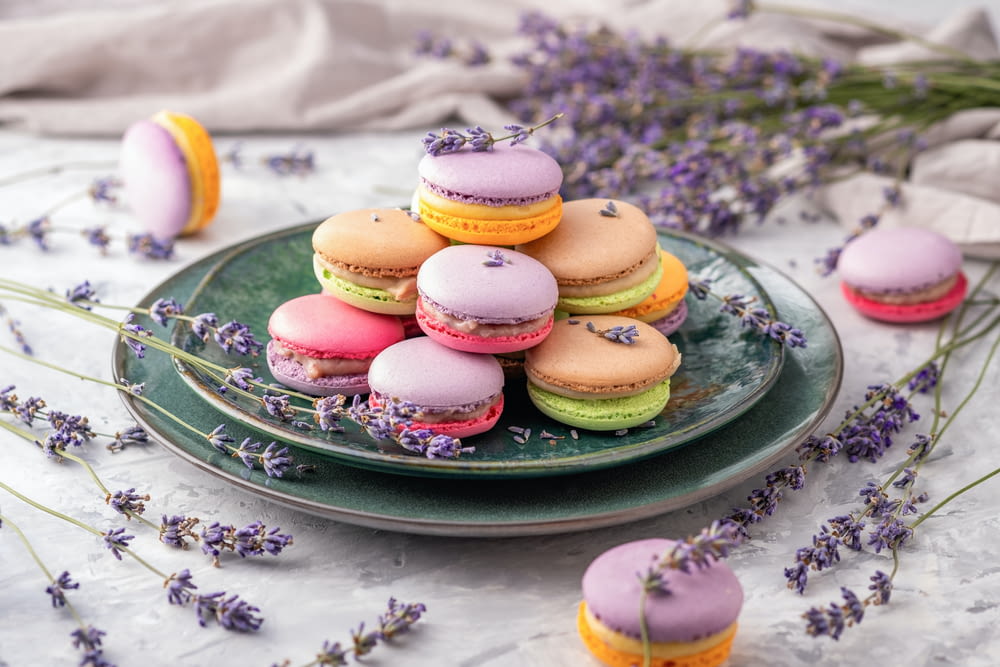 a plate of colorful french macaroons on a table