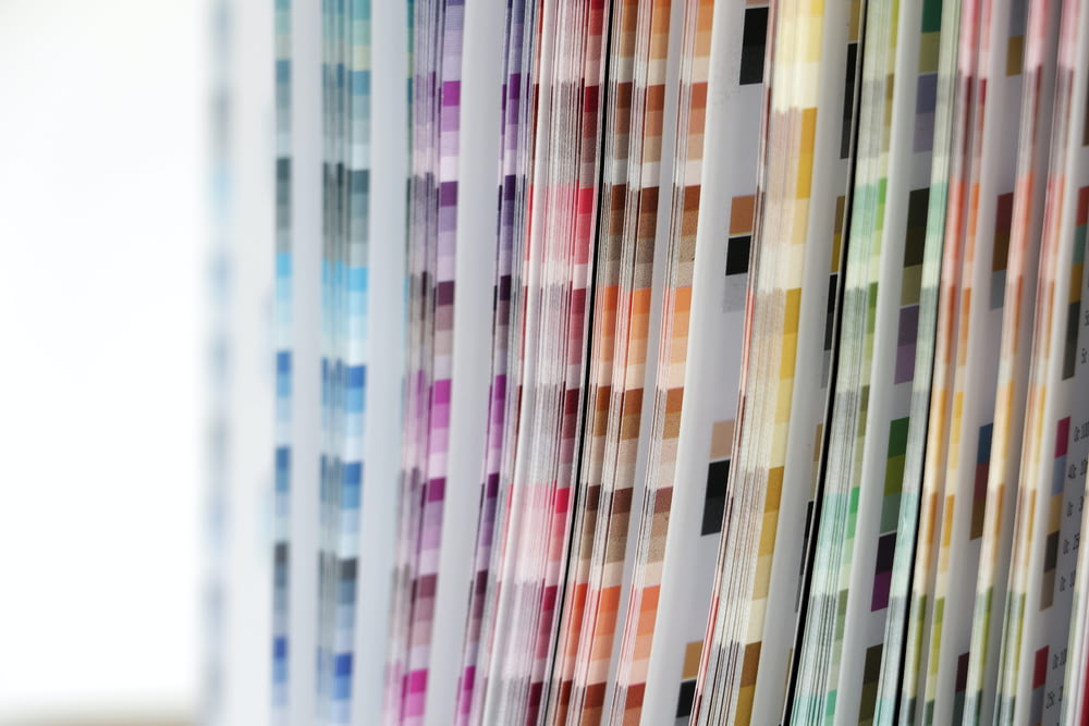 a close up of a number of different colored papers
