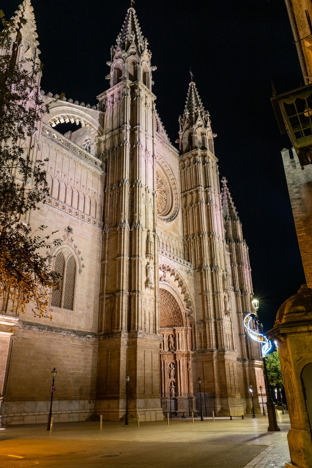 a large cathedral lit up at night with a clock