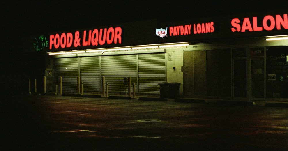 a food and liquor store lit up at night