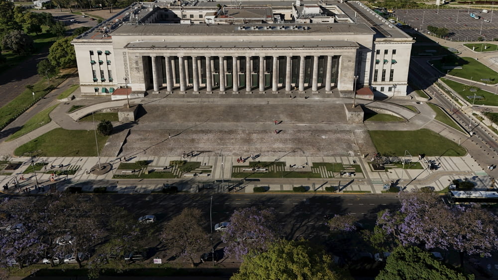 an aerial view of a large building with columns