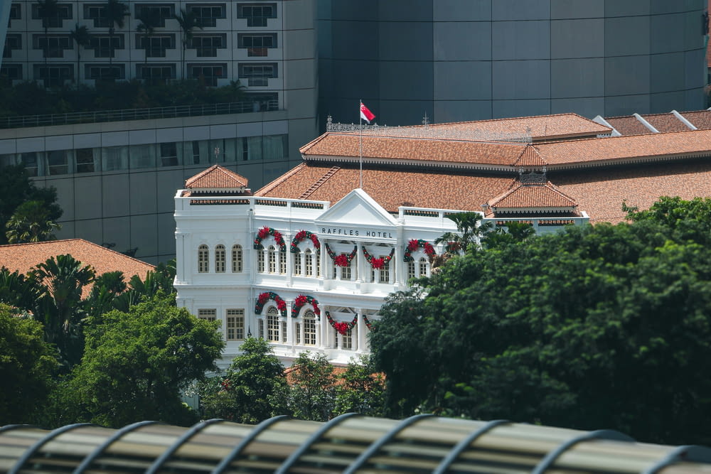 a large white building with a flag on top of it