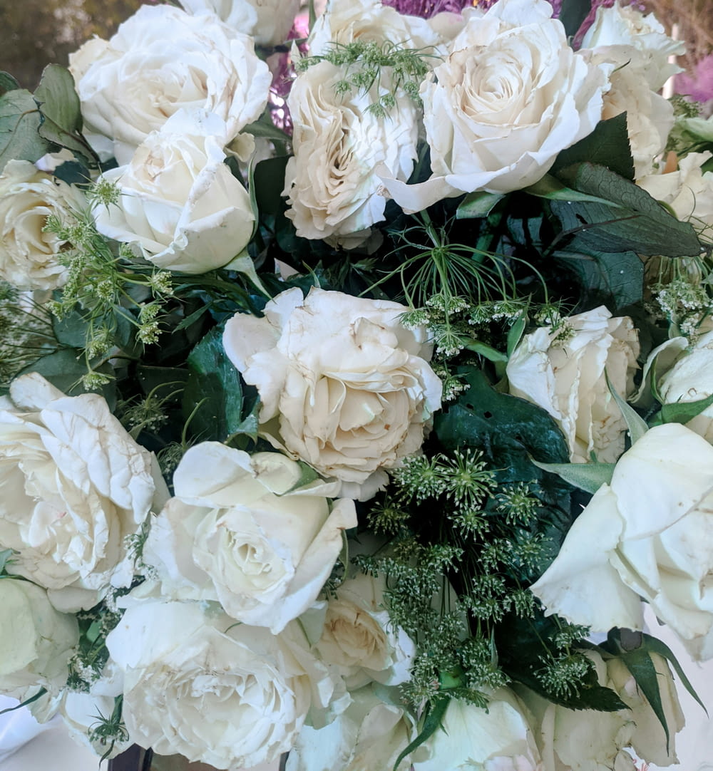 a bouquet of white flowers sitting on top of a table