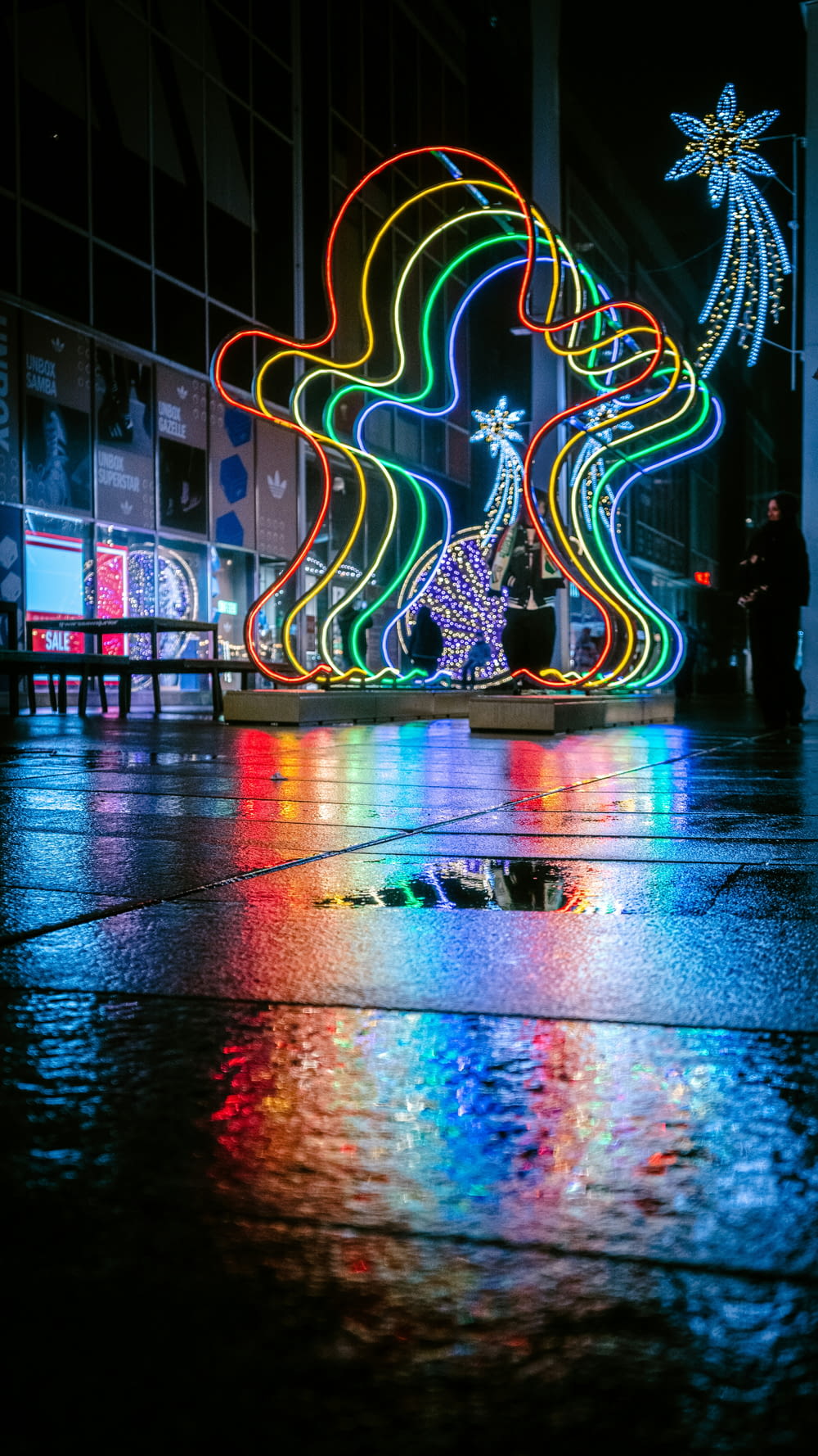a colorful display of lights on a rainy night