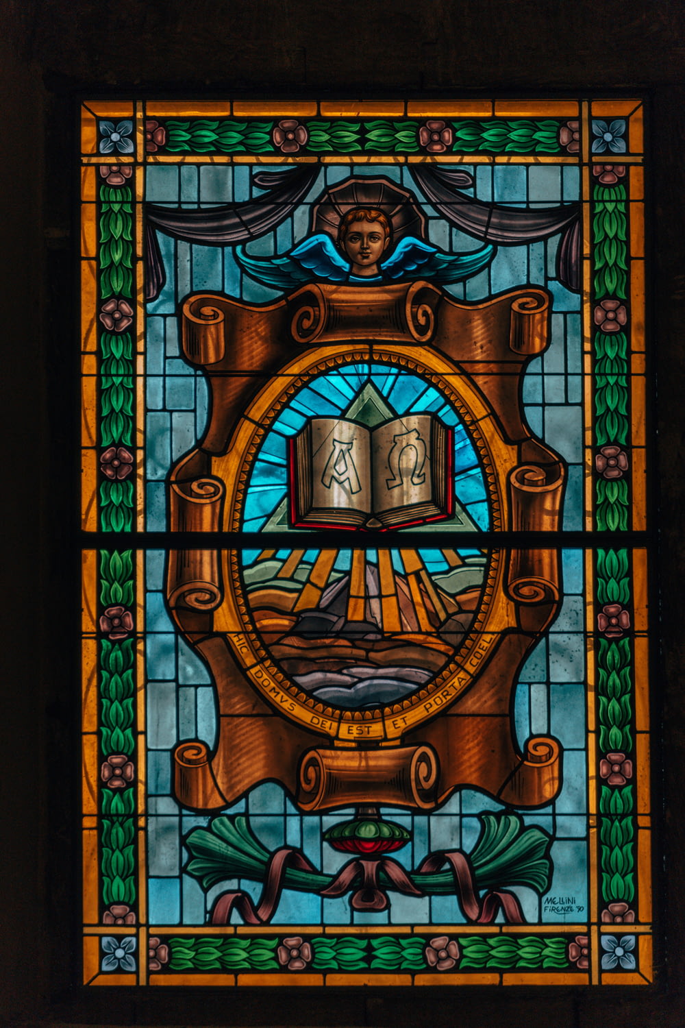 a stained glass window with a ship on it