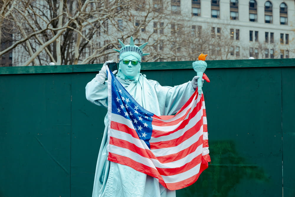 a statue of liberty holding an american flag