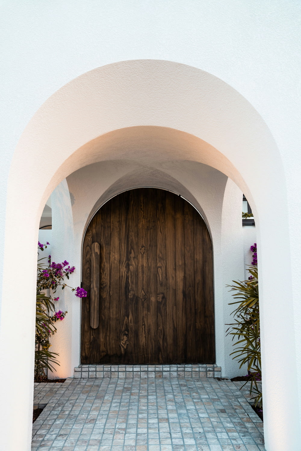a white building with a large wooden door