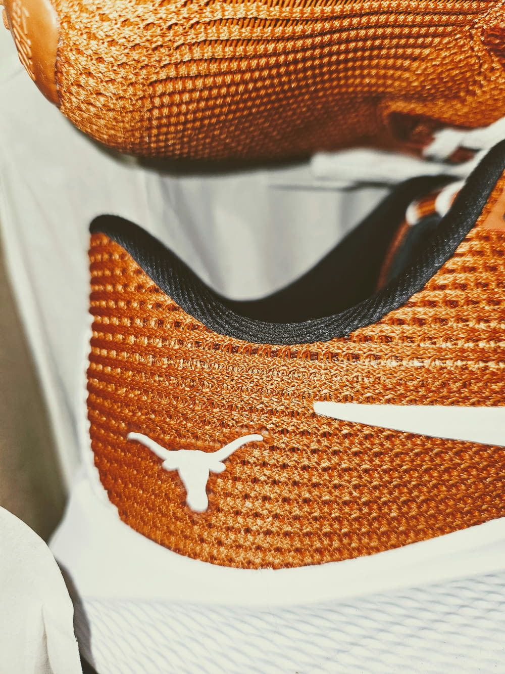a close up of a pair of orange and white shoes