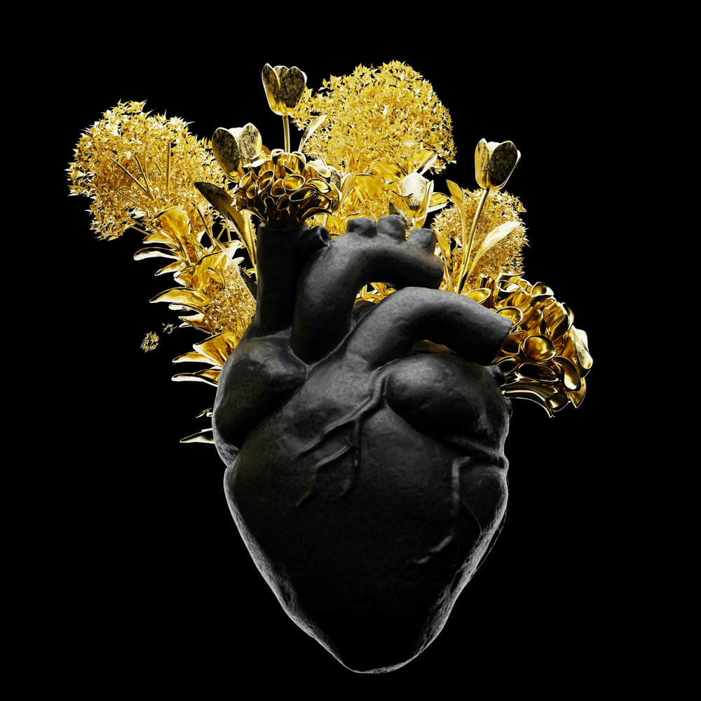 a black heart with yellow flowers on a black background