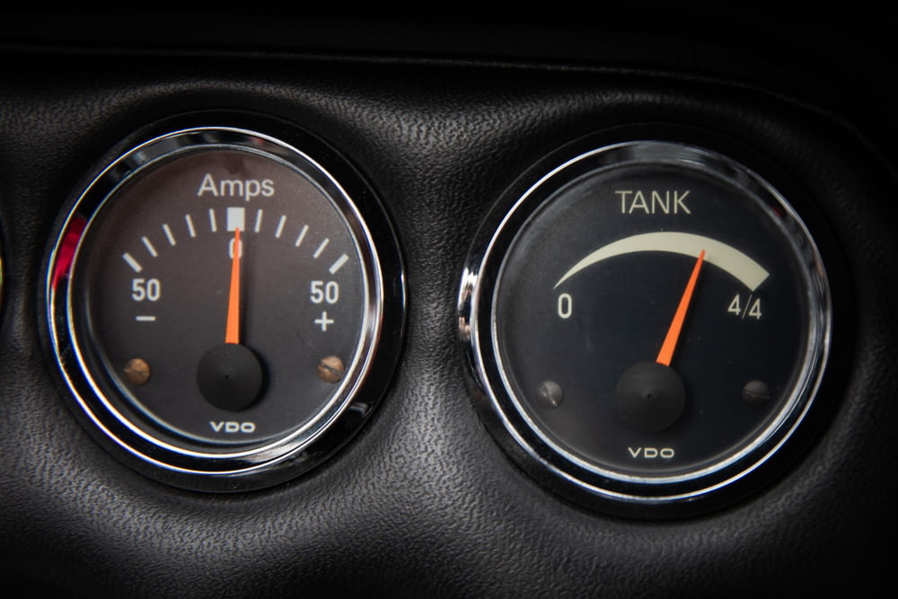 a close up of two gauges in a car