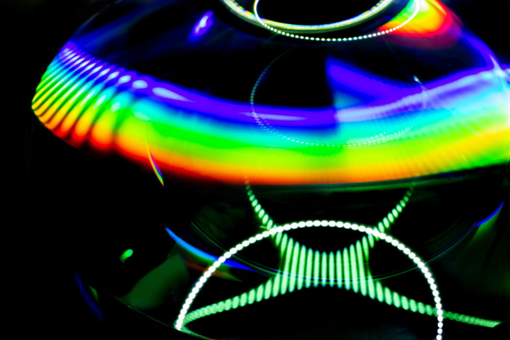 a rainbow colored object with a black background
