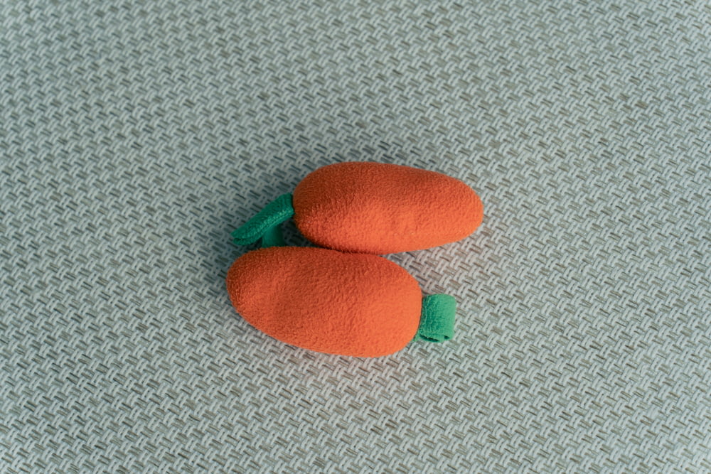 two small carrots sitting on top of a table