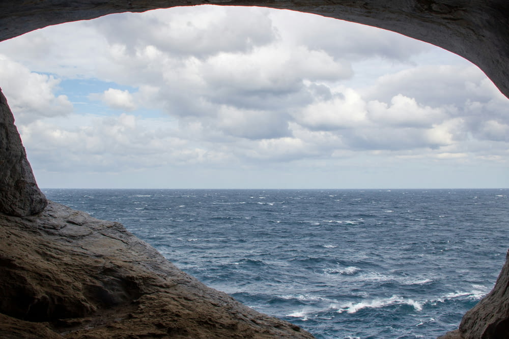 a view of the ocean from a cave