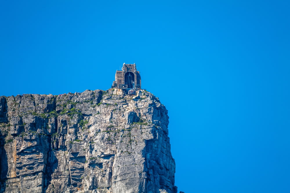 a very tall mountain with a small tower on top of it