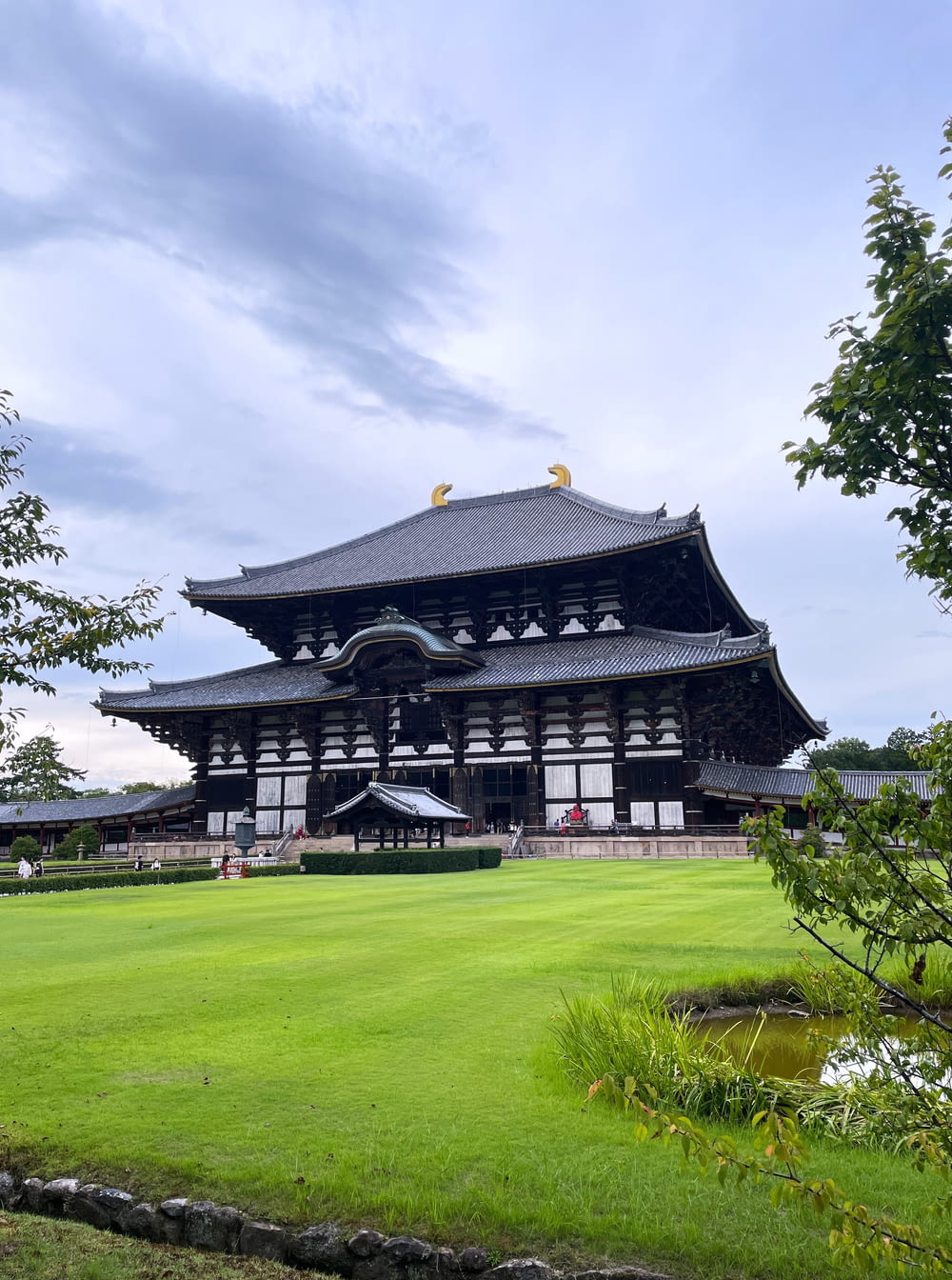 a large building sitting on top of a lush green field