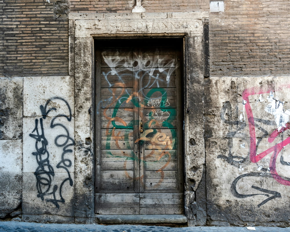 a door with a bunch of graffiti on it