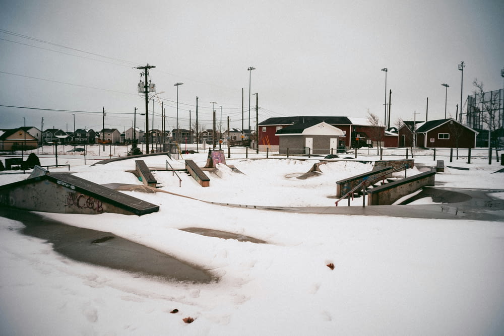 a group of skateboard ramps covered in snow