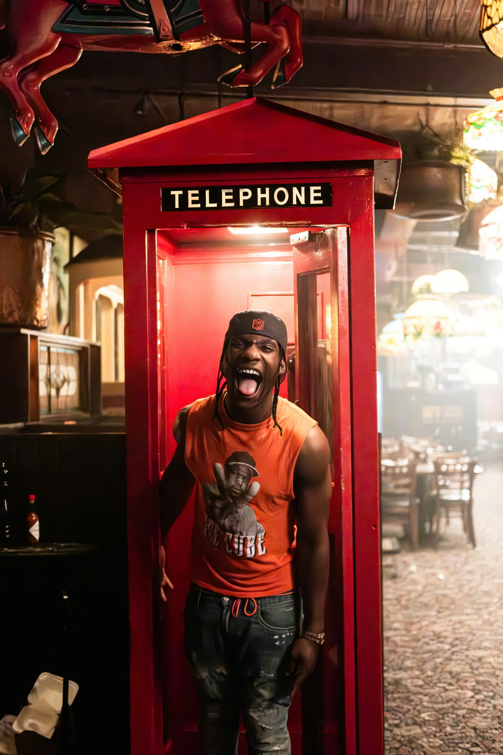 a man standing in a phone booth with his mouth open