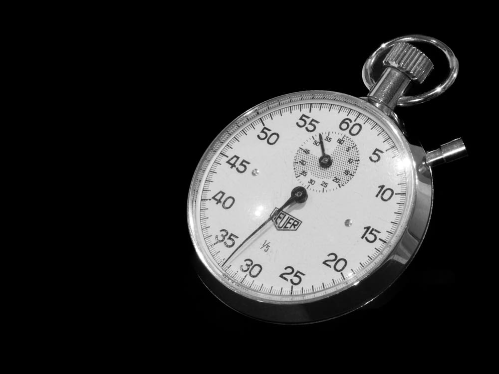 a close up of a stopwatch on a black background