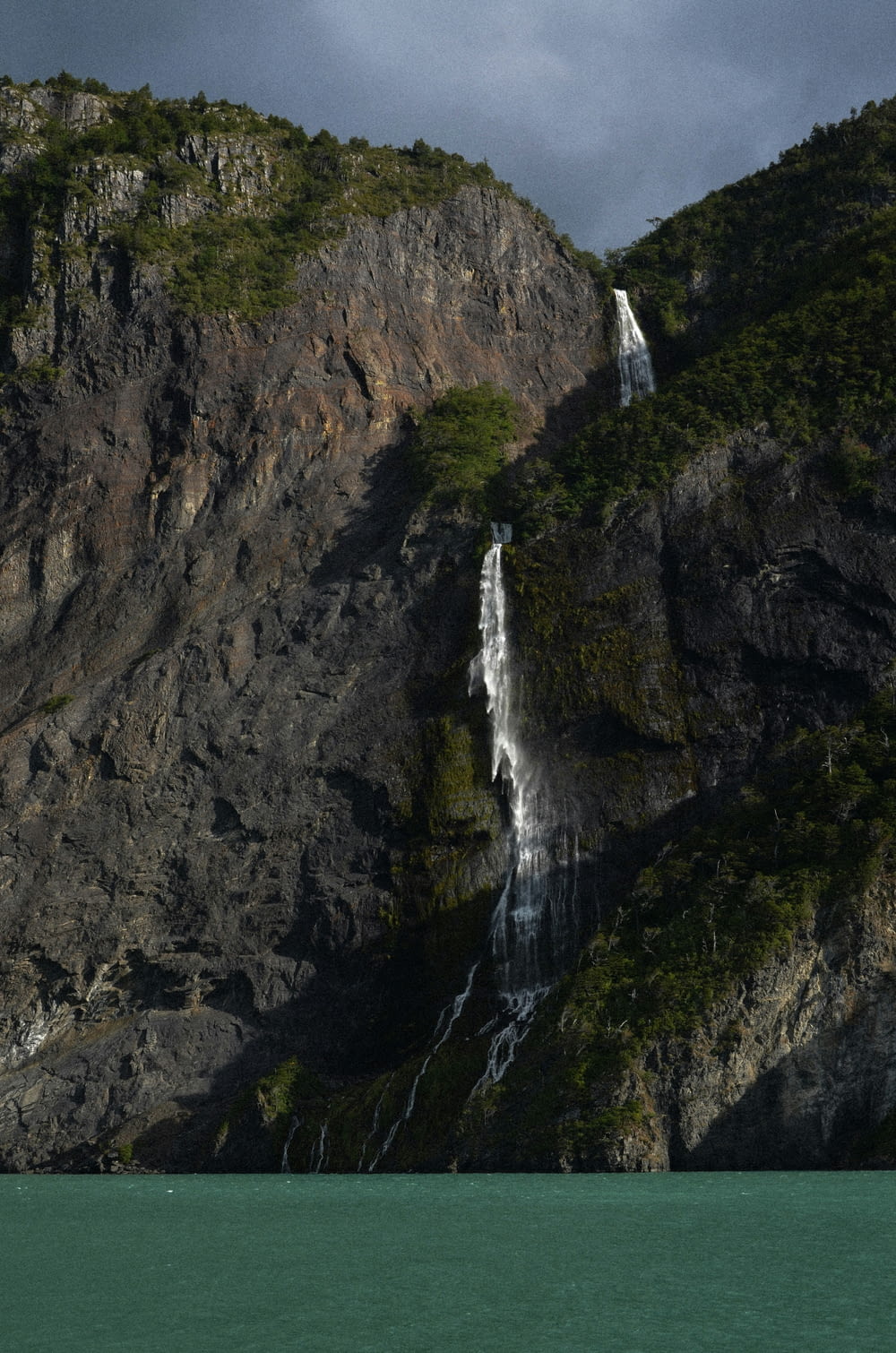 a large waterfall on the side of a mountain