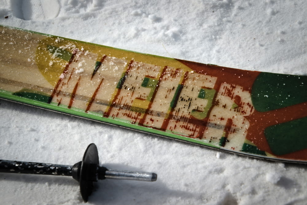 a snowboard that is laying in the snow